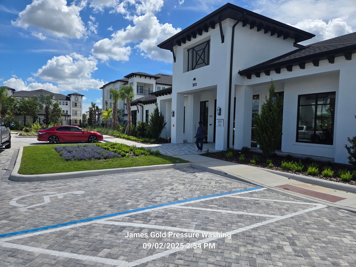 New apartment community clubhouse with paved parking and landscaped entrance in Central Florida