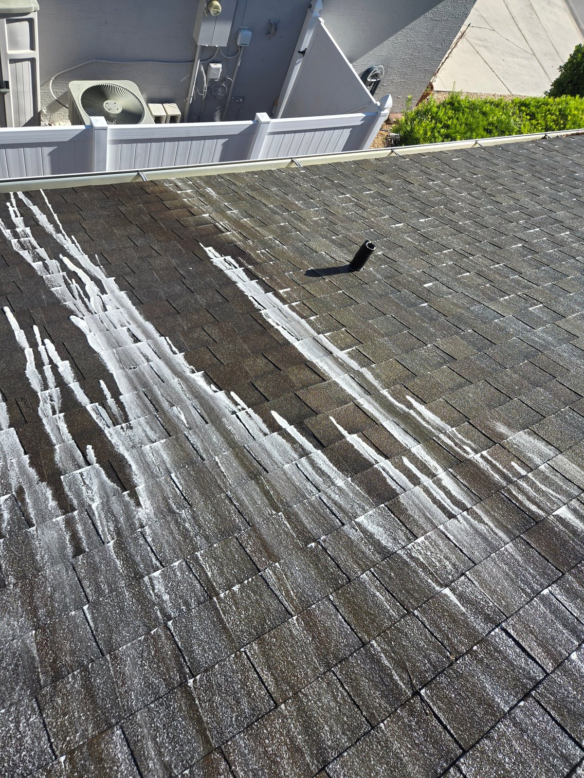 Asphalt roof with white chalk markings and measurements for inspection or repair work